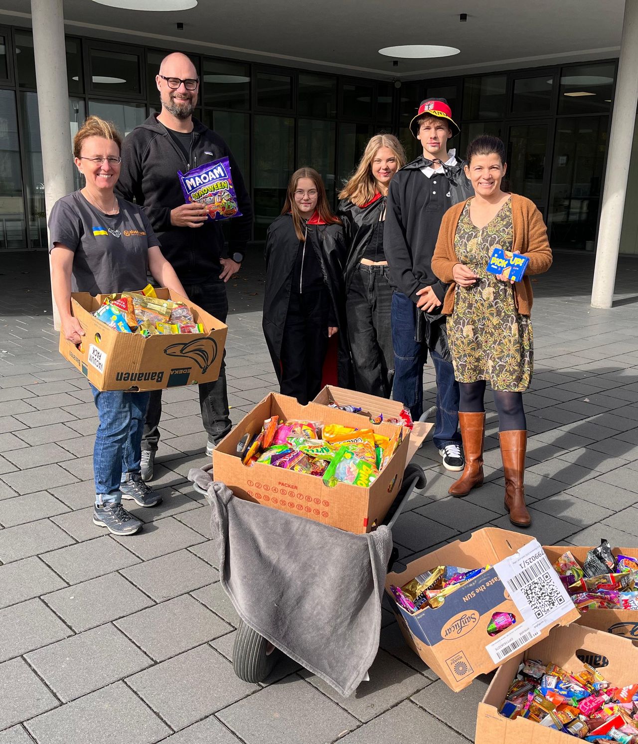 SMV-Team bei der Spendenübergabe der Halloweenaktion vor dem Haupteingang der Realschule